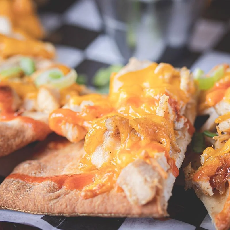 Official Wurst Haus photograph of a cheese-topped appetizer; exact dish name unconfirmed